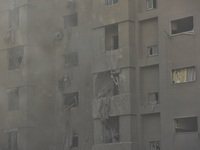 Firefighters extinguish the blaze at the site of overnight Israeli airstrikes that target the neighborhood of Kafaat in Beirut's southern su...