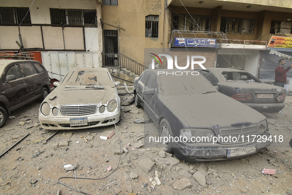 Firefighters extinguish the blaze at the site of overnight Israeli airstrikes that target the neighborhood of Kafaat in Beirut's southern su...