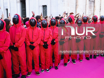 A cosplayer attends the photocall for the press conference of Netflix's Squid Game Season 2 at Lucca Comics & Games in Lucca, Italy, on Octo...