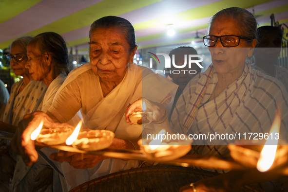 Elderly women at Pramod Talukdar Memorial Old Age Home light Diya oil lamps as they celebrate Diwali in Guwahati, India, on November 1, 2024...