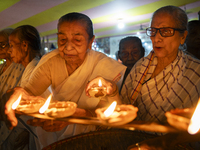 Elderly women at Pramod Talukdar Memorial Old Age Home light Diya oil lamps as they celebrate Diwali in Guwahati, India, on November 1, 2024...