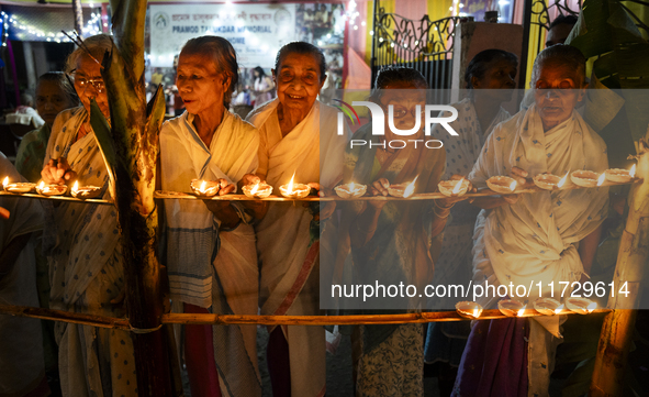 Elderly women at Pramod Talukdar Memorial Old Age Home light Diya oil lamps as they celebrate Diwali in Guwahati, India, on November 1, 2024...