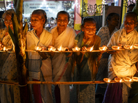 Elderly women at Pramod Talukdar Memorial Old Age Home light Diya oil lamps as they celebrate Diwali in Guwahati, India, on November 1, 2024...