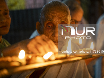 Elderly women at Pramod Talukdar Memorial Old Age Home light Diya oil lamps as they celebrate Diwali in Guwahati, India, on November 1, 2024...