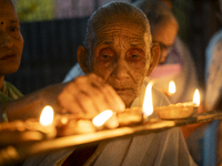 Elderly women at Pramod Talukdar Memorial Old Age Home light Diya oil lamps as they celebrate Diwali in Guwahati, India, on November 1, 2024...