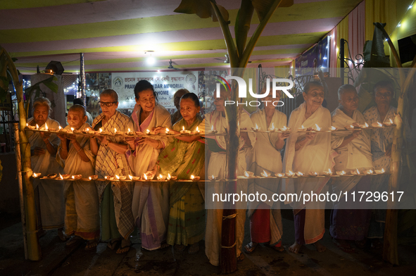 Elderly women at Pramod Talukdar Memorial Old Age Home light Diya oil lamps as they celebrate Diwali in Guwahati, India, on November 1, 2024...