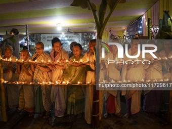 Elderly women at Pramod Talukdar Memorial Old Age Home light Diya oil lamps as they celebrate Diwali in Guwahati, India, on November 1, 2024...