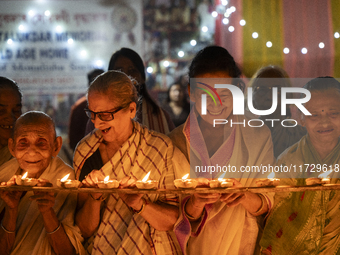 Elderly women at Pramod Talukdar Memorial Old Age Home light Diya oil lamps as they celebrate Diwali in Guwahati, India, on November 1, 2024...