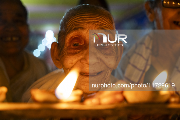 Elderly women at Pramod Talukdar Memorial Old Age Home light Diya oil lamps as they celebrate Diwali in Guwahati, India, on November 1, 2024...