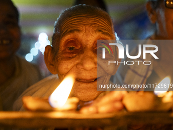 Elderly women at Pramod Talukdar Memorial Old Age Home light Diya oil lamps as they celebrate Diwali in Guwahati, India, on November 1, 2024...