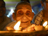 Elderly women at Pramod Talukdar Memorial Old Age Home light Diya oil lamps as they celebrate Diwali in Guwahati, India, on November 1, 2024...