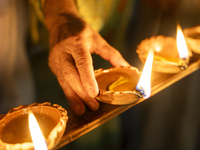 Elderly women at Pramod Talukdar Memorial Old Age Home light Diya oil lamps as they celebrate Diwali in Guwahati, India, on November 1, 2024...