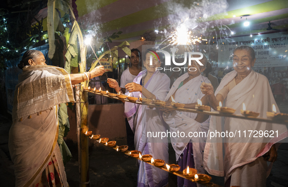 Elderly women at Pramod Talukdar Memorial Old Age Home burn sparkler crackers as they celebrate Diwali in Guwahati, India, on November 1, 20...