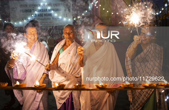 Elderly women at Pramod Talukdar Memorial Old Age Home burn sparkler crackers as they celebrate Diwali in Guwahati, India, on November 1, 20...