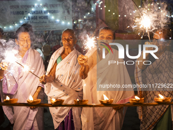 Elderly women at Pramod Talukdar Memorial Old Age Home burn sparkler crackers as they celebrate Diwali in Guwahati, India, on November 1, 20...