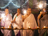 Elderly women at Pramod Talukdar Memorial Old Age Home burn sparkler crackers as they celebrate Diwali in Guwahati, India, on November 1, 20...