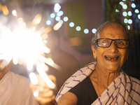 An elderly woman at Pramod Talukdar Memorial Old Age Home burns sparkler crackers as she celebrates Diwali in Guwahati, India, on November 1...