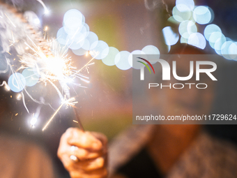 An elderly woman at Pramod Talukdar Memorial Old Age Home burns sparkler crackers as she celebrates Diwali in Guwahati, India, on November 1...