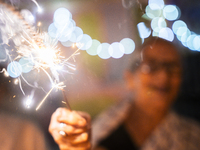 An elderly woman at Pramod Talukdar Memorial Old Age Home burns sparkler crackers as she celebrates Diwali in Guwahati, India, on November 1...