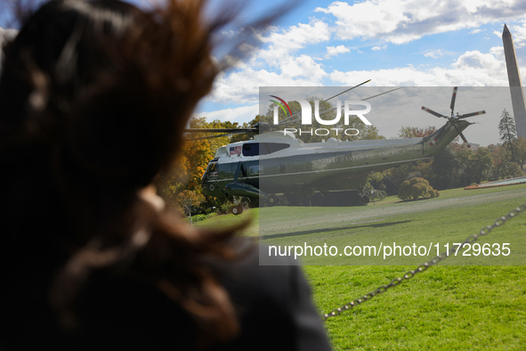 Seen beyond a member of the press, Marine One carrying U.S. President Joe Biden departs the South Lawn of the White House in Washington, D.C...