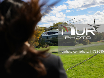 Seen beyond a member of the press, Marine One carrying U.S. President Joe Biden departs the South Lawn of the White House in Washington, D.C...