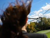 Seen beyond a member of the press, Marine One carrying U.S. President Joe Biden departs the South Lawn of the White House in Washington, D.C...