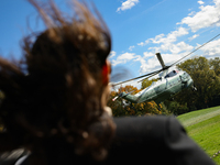 Seen beyond a member of the press, Marine One carrying U.S. President Joe Biden departs the South Lawn of the White House in Washington, D.C...