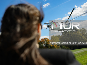 Seen beyond a member of the press, Marine One carrying U.S. President Joe Biden departs the South Lawn of the White House in Washington, D.C...