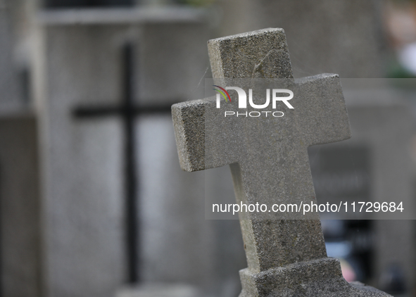 A tombstone in the form of a cross stands at the Rakowicki Cemetery during preparations for All Saints' Day in Krakow, Poland, on October 30...