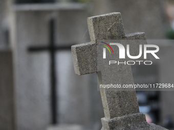 A tombstone in the form of a cross stands at the Rakowicki Cemetery during preparations for All Saints' Day in Krakow, Poland, on October 30...