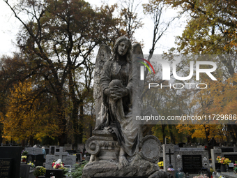 A tombstone in the form of a sculpture is at the Rakowicki Cemetery during preparations for All Saints' Day in Krakow, Poland, on October 30...