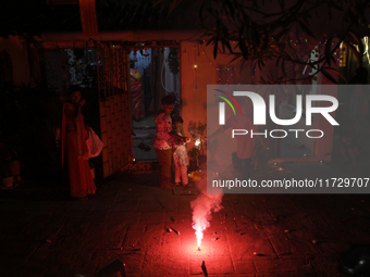 Children play with firecrackers during Diwali, the Hindu festival of lights, in Mumbai, India, on November 1, 2024. (