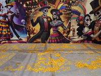 A mural in Santiago Zapotitlan, Tlahuac, in Mexico City, on November 1, 2024, faces the community cemetery where dozens of people decorate t...