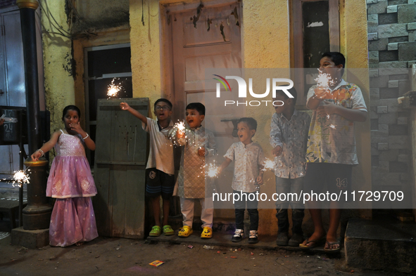 Children play with firecrackers during Diwali, the Hindu festival of lights, in Mumbai, India, on November 1, 2024. 