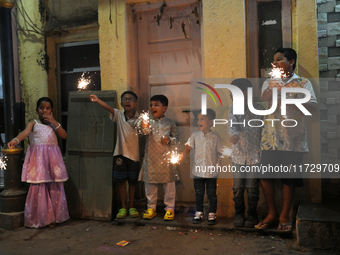 Children play with firecrackers during Diwali, the Hindu festival of lights, in Mumbai, India, on November 1, 2024. (