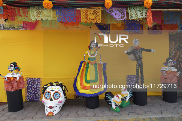 Residents of Santiago Zapotitlan in Mexico City, Mexico, on November 1, 2024, decorate their homes with cardboard skulls. They go to the com...