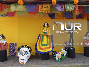 Residents of Santiago Zapotitlan in Mexico City, Mexico, on November 1, 2024, decorate their homes with cardboard skulls. They go to the com...