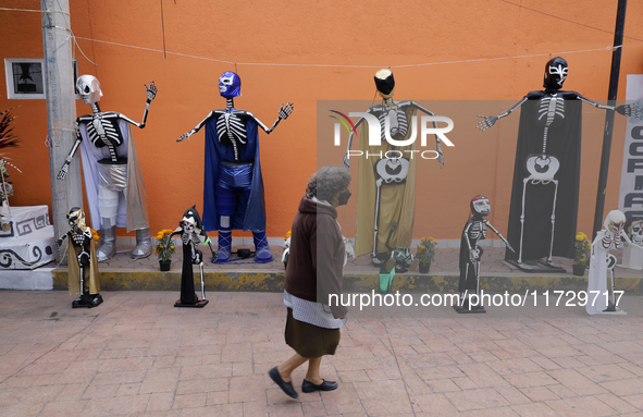 Residents of Santiago Zapotitlan in Mexico City, Mexico, on November 1, 2024, decorate their homes with cardboard skulls. They go to the com...