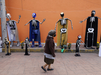 Residents of Santiago Zapotitlan in Mexico City, Mexico, on November 1, 2024, decorate their homes with cardboard skulls. They go to the com...