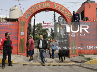 The entrance to the old pantheon of Santiago Zapotitlan in Mexico City, Mexico, on November 1, 2024, where inhabitants decorate the graves o...