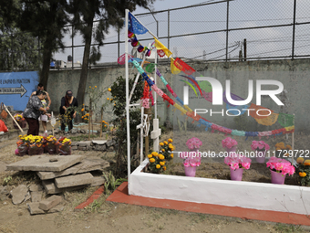 Residents of Santiago Zapotitlan in Mexico City, Mexico, on November 1, 2024, attend the old cemetery to decorate the graves of their deceas...