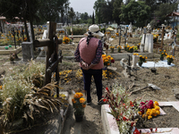 Residents of Santiago Zapotitlan in Mexico City, Mexico, on November 1, 2024, attend the old cemetery to decorate the graves of their deceas...