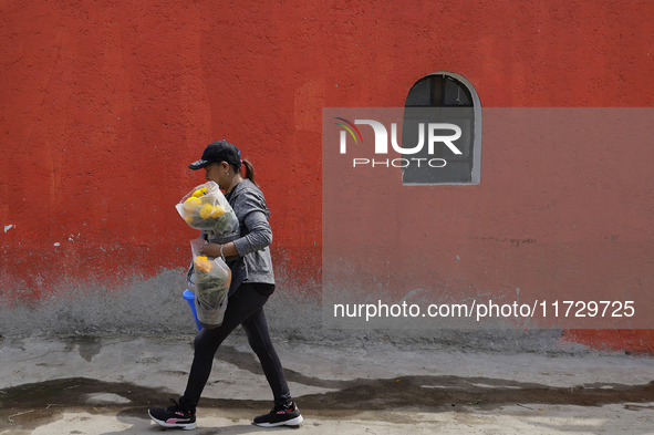 Residents of Santiago Zapotitlan in Mexico City, Mexico, on November 1, 2024, attend the old cemetery to decorate the graves of their deceas...