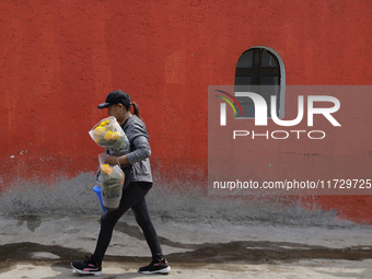 Residents of Santiago Zapotitlan in Mexico City, Mexico, on November 1, 2024, attend the old cemetery to decorate the graves of their deceas...