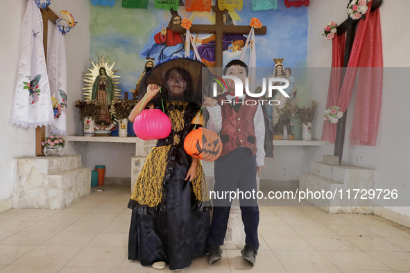 A girl and a boy dress up inside a chapel in the old Santiago Zapotitlan cemetery in Mexico City, Mexico, on November 1, 2024, where dozens...