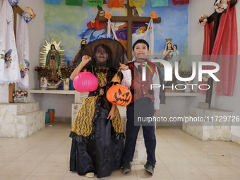 A girl and a boy dress up inside a chapel in the old Santiago Zapotitlan cemetery in Mexico City, Mexico, on November 1, 2024, where dozens...