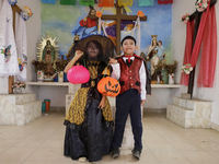 A girl and a boy dress up inside a chapel in the old Santiago Zapotitlan cemetery in Mexico City, Mexico, on November 1, 2024, where dozens...