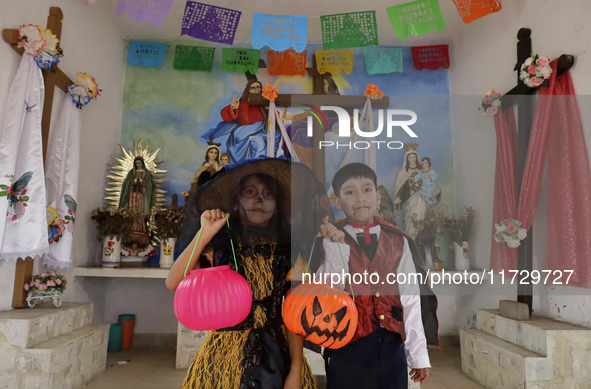 A girl and a boy dress up inside a chapel in the old Santiago Zapotitlan cemetery in Mexico City, Mexico, on November 1, 2024, where dozens...