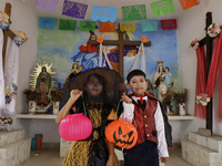 A girl and a boy dress up inside a chapel in the old Santiago Zapotitlan cemetery in Mexico City, Mexico, on November 1, 2024, where dozens...