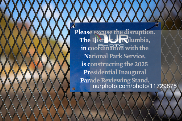 A sign hanging on a fence informs people of construction for the 2025 Presidential Inaugural Parade Reviewing Stand on Pennsylvania Avenue o...